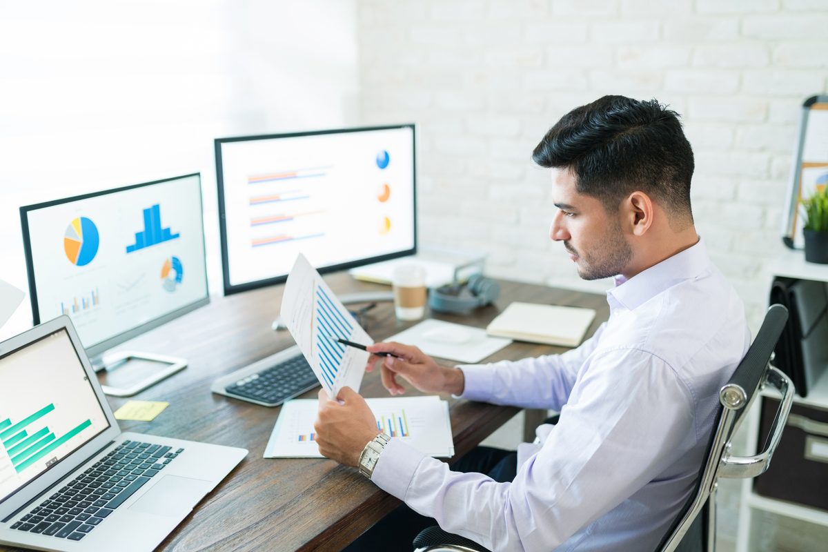 A data scientist reviewing models on a laptop