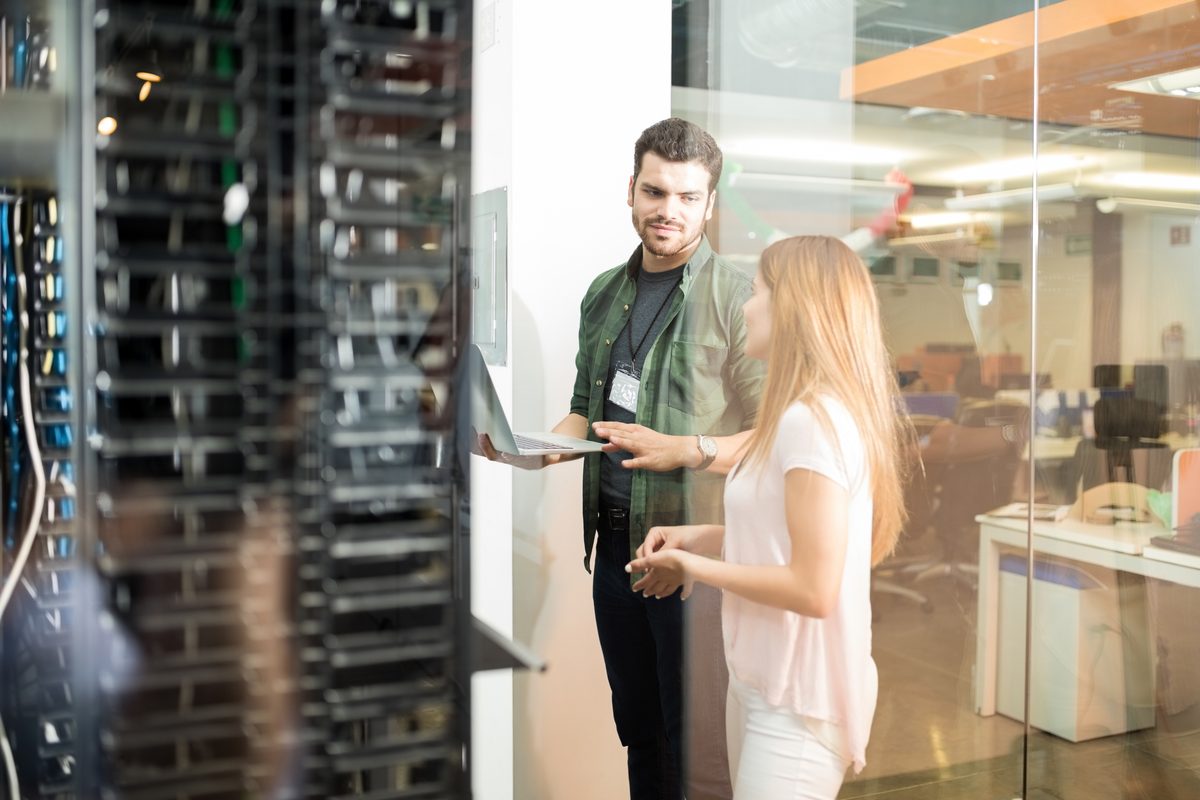 Data engineers collaborating around a laptop